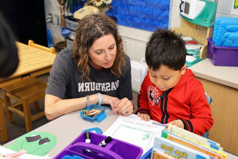 Teacher works with a student